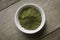 Stevia powder in white plate on wooden background