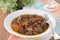 Stew of beef with vegetables and prunes in a plate