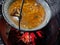 Stew cooked in a pot, outside over a wood fire