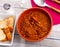 Stew of lentils with meat, chorizo and vegetables in clay bowl