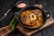 Stew veal shank meat OssoBuco, italian osso buco steak. Black wooden background. Top view