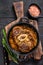 Stew veal shank meat OssoBuco, italian osso buco steak. Black wooden background. Top view