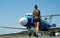 Stewardess in blue uniform - back view. Pretty female flight attendant in airport. Charming stewardess dressed in blue