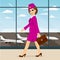 Stewardess with briefcase walking through airport terminal