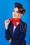 Stewardess with face art corrects neckerchief.