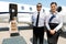 Stewardess And Pilot Standing Against Private Jet