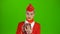 Stewardess in the red attire looks into the phone and is surprised. Green Screen