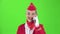 Stewardess in a red suit speaks on the phone . Green screen. Slow motion