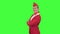 Stewardess in a red suit winks a slight flirt. Green screen. Side view