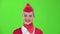 Stewardess smiles looks into the distance. Green screen. Slow motion. Close up