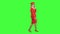 Stewardess speaks on the phone and paces into the distance. Green screen. Side view