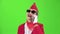 Stewardess in sunglasses in a red suit speaks on the phone . Green screen. Slow motion
