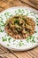 Stewed chicken stomachs with vegetables and buckwheat. Wooden background. Top view