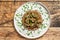 Stewed chicken stomachs with vegetables and buckwheat. Wooden background. Top view