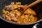 Stewed meat with potatoes in a large pot. Cooking homemade pork stew with boiled potatoes. Close-up of braised meat in a saucepan