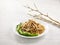 Stewed Mee Pok with Vegetarian Ham served in a dish isolated on wooden board side view on grey background