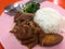 Stewed pork leg on rice for Thai meal in local market stall