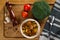 Stewed tomatoes with broccoli in a plate on a wooden background