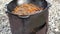 Stewing carrots with meat for Uzbek pilaf in a cauldron on a stove