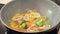 Stewing squid and vegetables in a wok