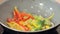 Stewing squid and vegetables in a wok