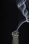 A Stick of Burning Buffalo Sage with Beautiful Flowing Smoke on a Black Background