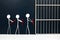 Stick man figure handcuffed tied with red rope going to a jail prison in dark background. Hostage, political prisoner, human right