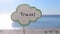 Stick with paper speech bubble with words Travel on background sea, sky, sandy