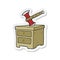 sticker of a cartoon axe buried in chest of drawers