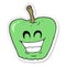 sticker of a cartoon grinning apple