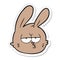 sticker of a cartoon jaded rabbit face