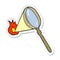 sticker of a cartoon magnifying glass burning