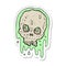 sticker of a cartoon slimy skull