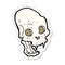 sticker of a cartoon spooky vampire skull