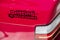 Sticker with the inscription drifting is not a crime on the red body of a sports drift car near the taillight. Close-up