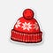 Sticker of red winter hat with pompon and snowflake pattern
