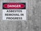 The sticker Sign danger asbestos removal on the plaster asbestos wall