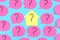 Stickers on a blue background. Pink stickers with question marks. In the center is a yellow sticker in the form of a