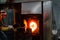 Sticking glass into the crucible furnace to heat it back up and shape it