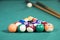 Sticks and billiard balls on the pool table