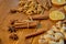 Sticks of cinnamon and anise stars on wooden brown background. Ingredients for mulled wine: dried fruits, orange, ginger, cinnamon