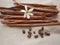 Sticks of cinnamon and coffee grains and white flower on canvas