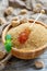 Sticks with crystal brown sugar in a wooden bowl.