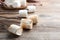 Sticks with roasted marshmallows on wooden table, closeup. Space for text