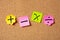 Sticky colorful notes in flower shape, isolated, with math symbols on corkboard