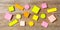 Sticky colorful notes in various shapes, isolated, copy space on wooden background.