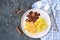 Sticky Indian style spiced chicken with a side dish of boiled potatoes and fresh cabbage salad on a white clay plate. Indian food