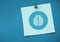 Sticky Note with brain Icon against neutral blue background