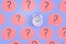 Sticky notes on a bright blue background. Pale orange stickers with question marks, in the center is an alarm clock. A