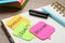 Sticky notes with words Diversity, Equality, Inclusion and stationery on wooden table, closeup